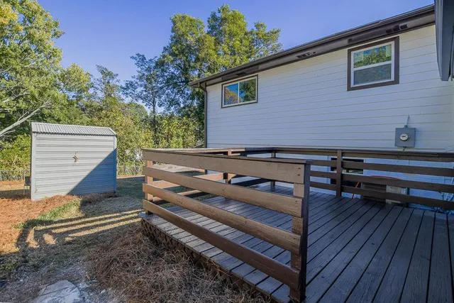a backyard of a house with barbeque oven and outdoor seating
