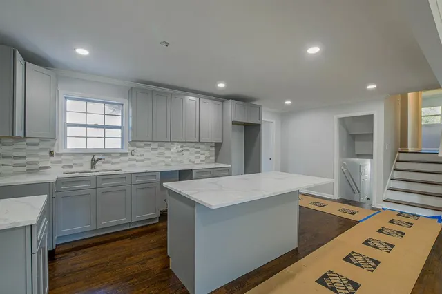 a kitchen with kitchen island sink refrigerator and stove
