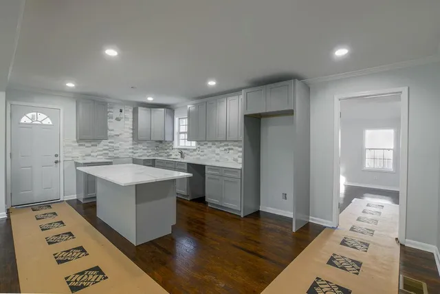 a kitchen with a sink stove and refrigerator