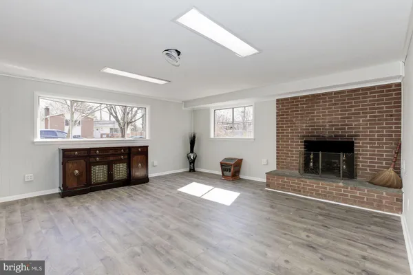 a living room with a fireplace and a wooden floor