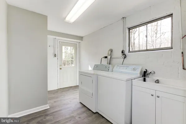 a utility room with cabinets washer and dryer