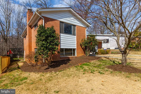 a view of a house with a yard covered in snow