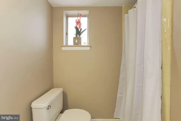 a white toilet sitting next to a bathroom sink