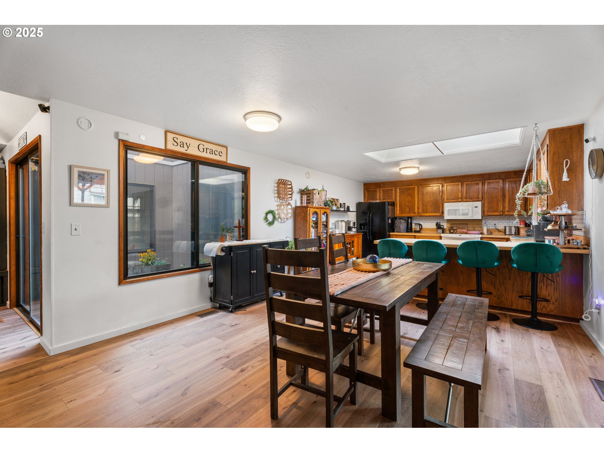 2356 B Street Hubbard, OR 97032 - Photo 12 of 32 a view of a dining room with furniture and wooden floor