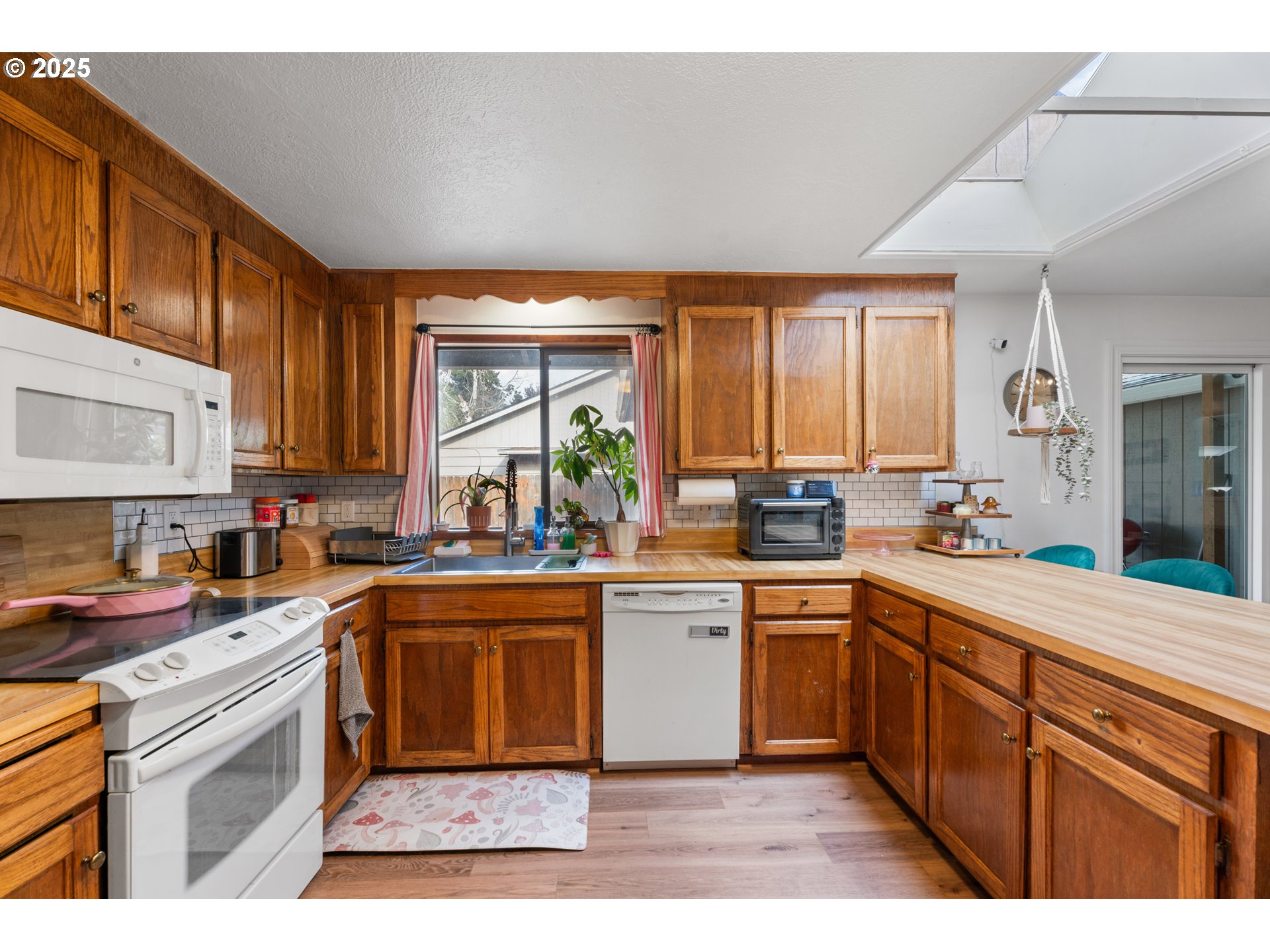 2356 B Street Hubbard, OR 97032 - Photo 15 of 32 a kitchen with stainless steel appliances granite countertop a stove sink and cabinets