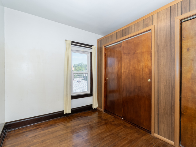 121 Davis Avenue, Unit 2 Rockdale, IL 60436 - Photo 7 of 11 a view of an empty room with closet and wooden floor