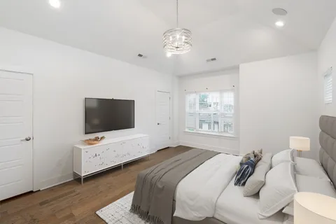 a bedroom with bed and tv