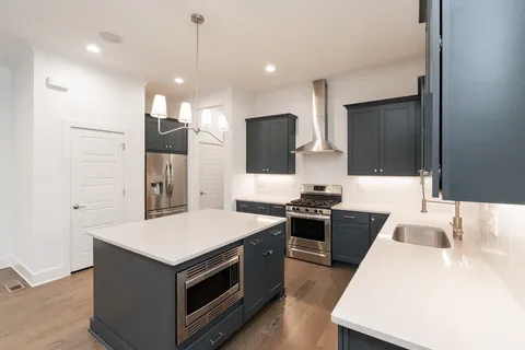a kitchen with a stove and a refrigerator