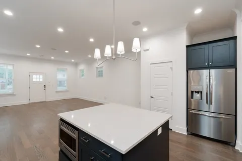 a kitchen with a refrigerator a sink and a counter top space