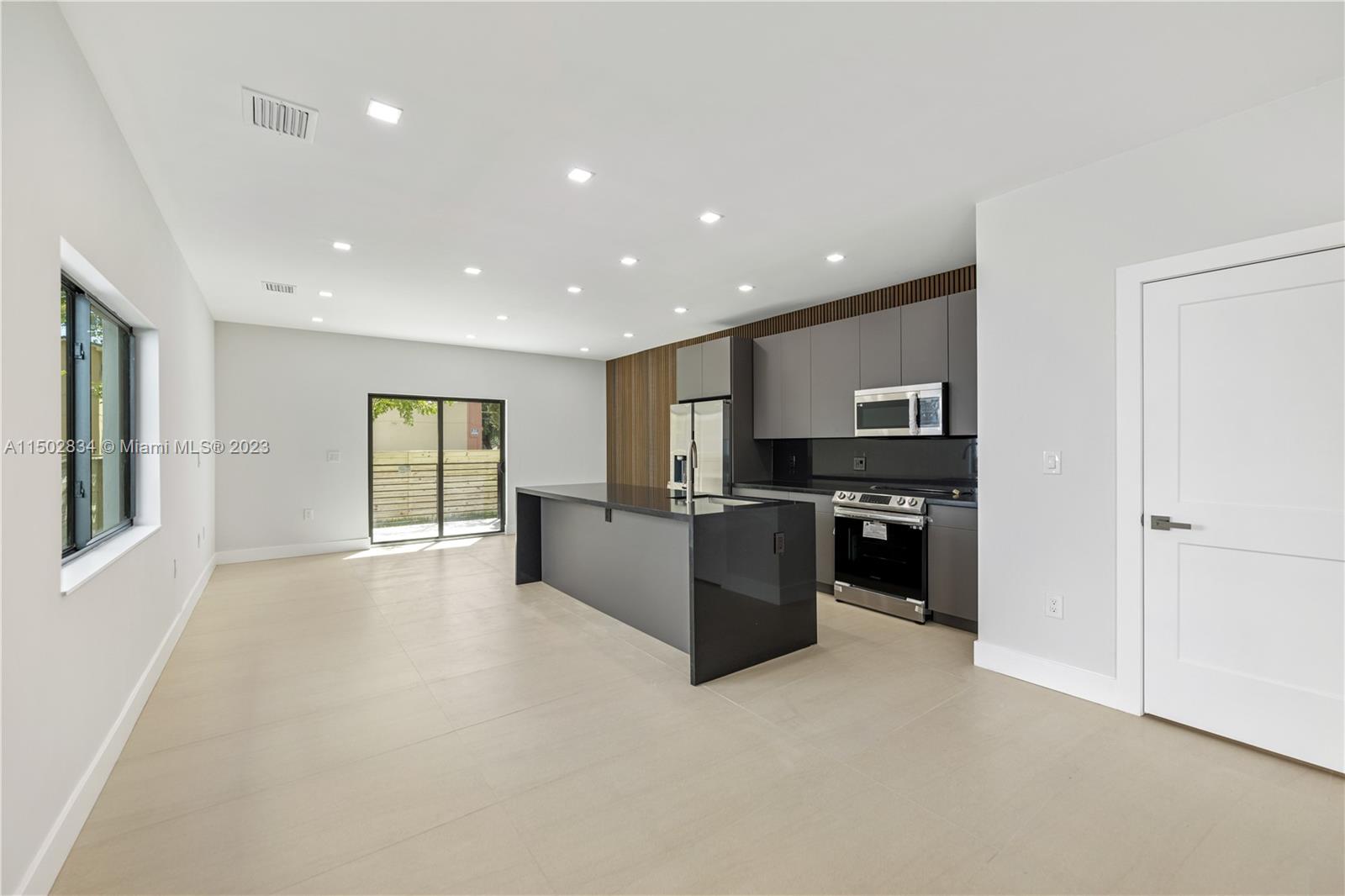 Allapattah Miami, FL 33142 - Photo 11 of 26 a view of kitchen with refrigerator and windows