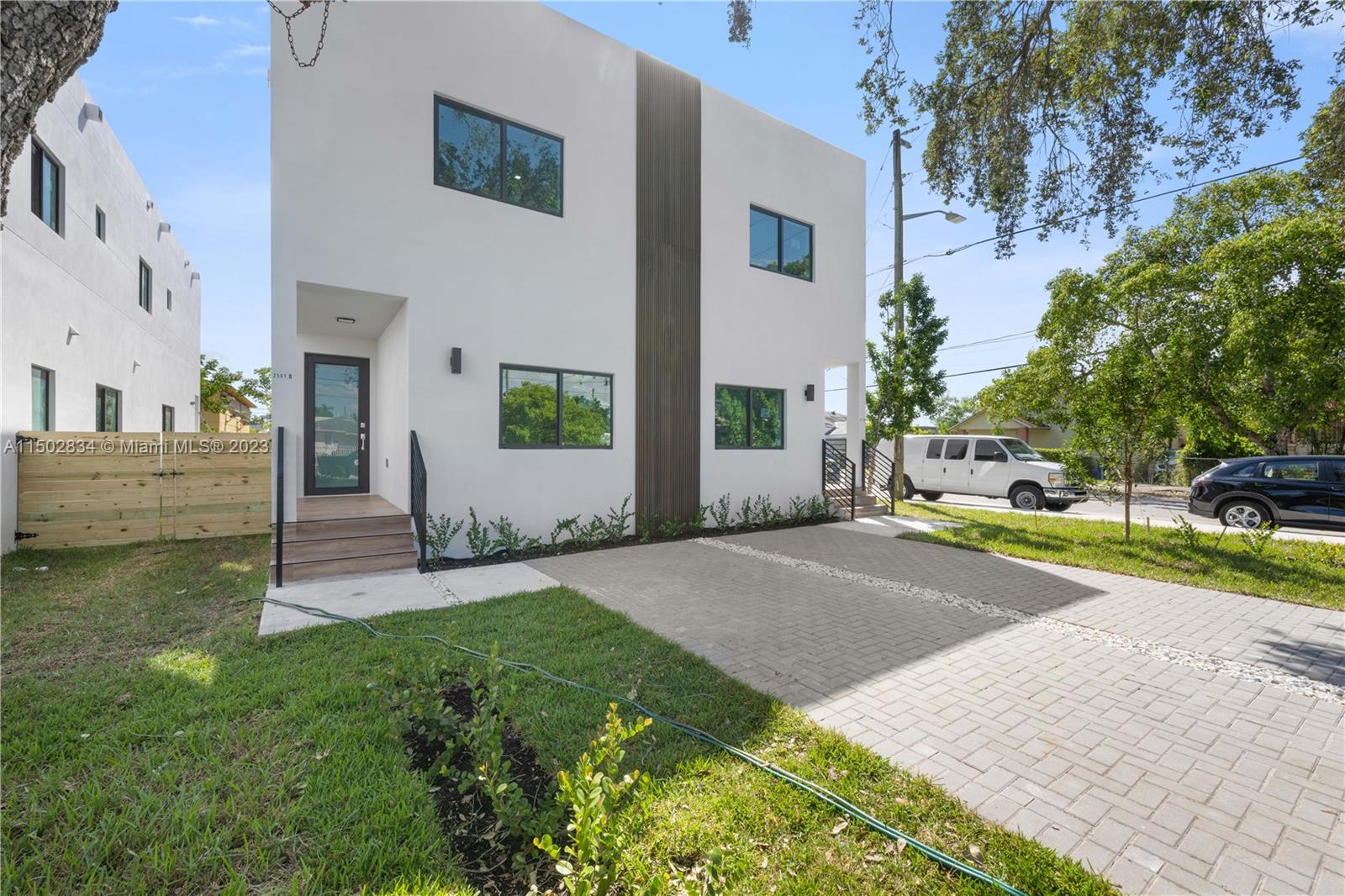 Allapattah Miami, FL 33142 - Photo 3 of 26 a view of a house with a yard and table and chairs under an umbrella