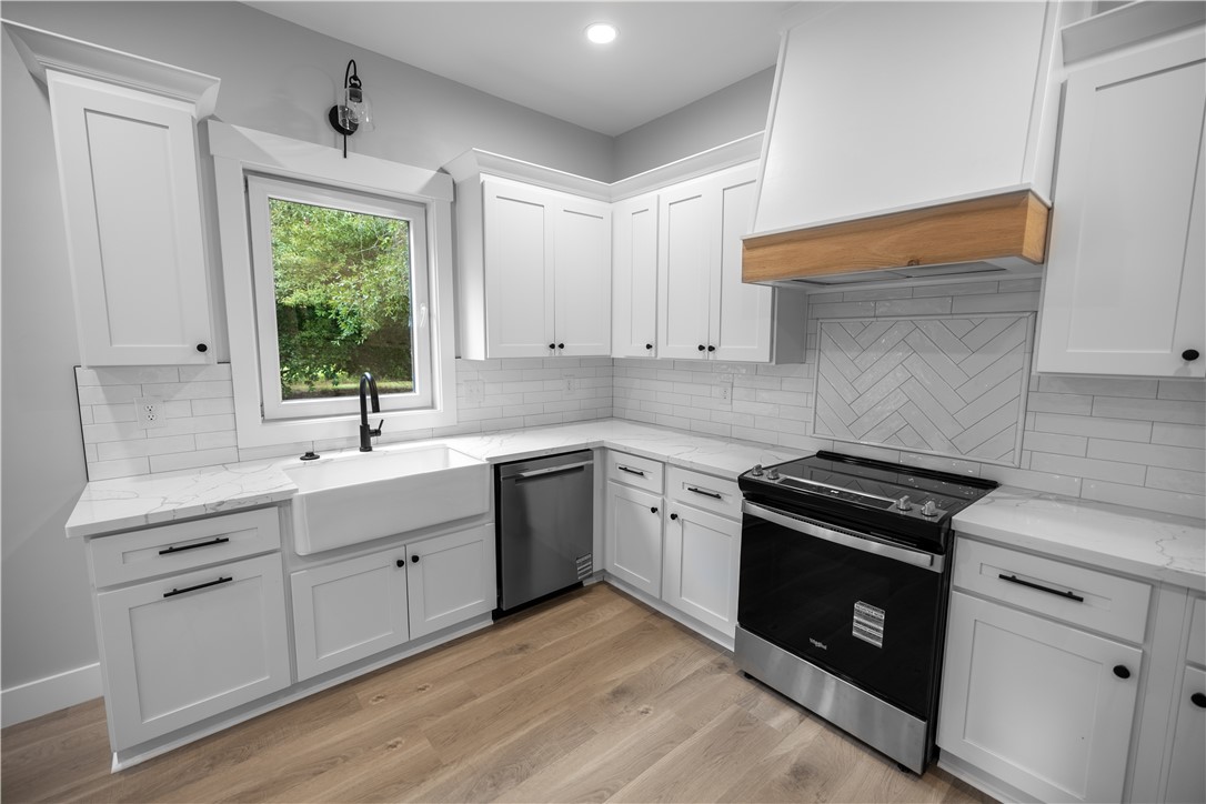 2817 Broadway Lake Road Anderson, SC 29621 - Photo 15 of 41 Culinary dreams come alive in this well-appointed kitchen, showcasing a large farmhouse sink and modern appliances.