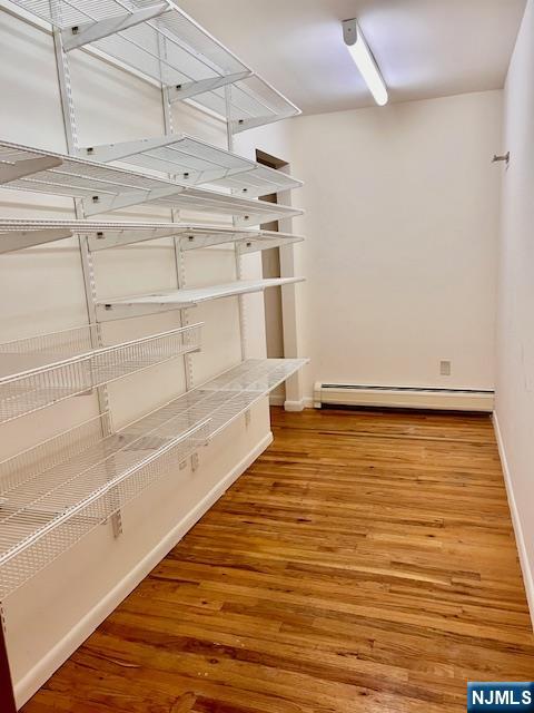 225 6th Street, Unit 2 Fairview, NJ 07022 - Photo 2 of 14 a view of an empty room with empty racks