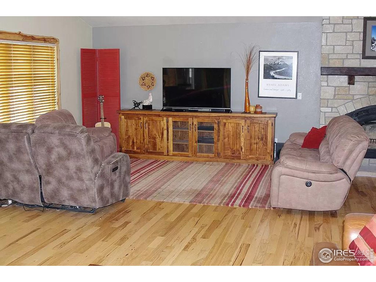 16705 Rist Canyon Road Bellvue, CO 80512 - Photo 9 of 25 a living room with furniture and a flat screen tv