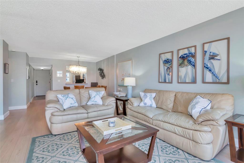 17580 Gulf Boulevard, Unit 403 Redington Shores, FL 33708 - Photo 13 of 27 a living room with furniture and a painting