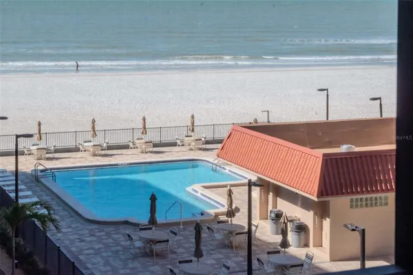 a view of a patio with swimming pool table and chairs