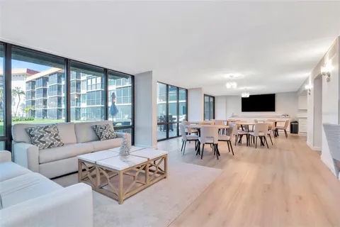a kitchen with granite countertop a stove a sink and a refrigerator