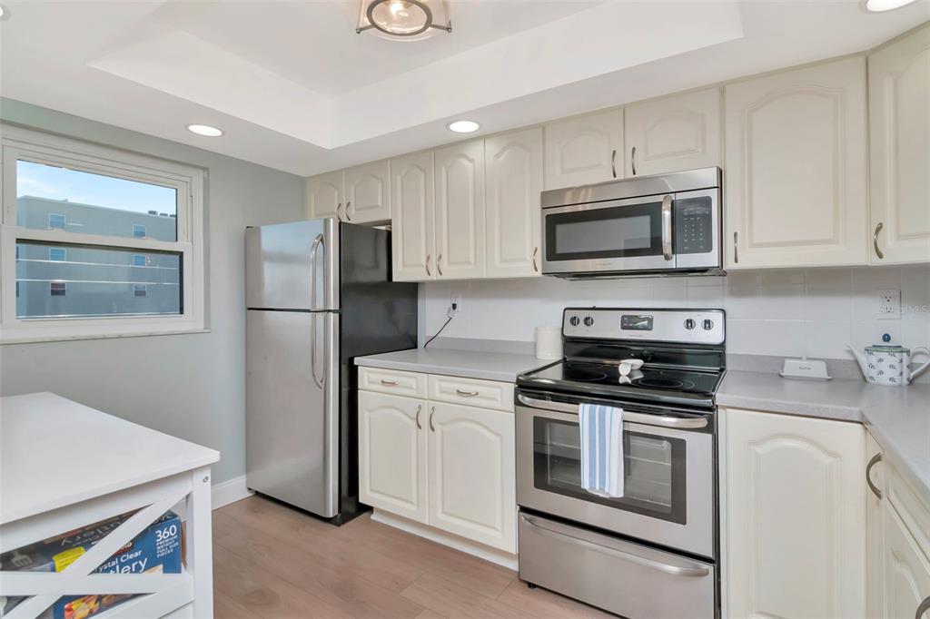 17580 Gulf Boulevard, Unit 403 Redington Shores, FL 33708 - Photo 4 of 27 a kitchen with cabinets stainless steel appliances and a counter space
