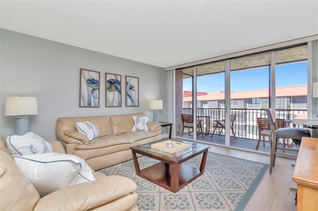 17580 Gulf Boulevard, Unit 403 Redington Shores, FL 33708 - Photo 10 of 27 a living room with furniture and a large window