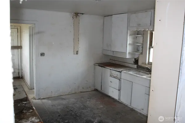 a kitchen with a sink stove and refrigerator