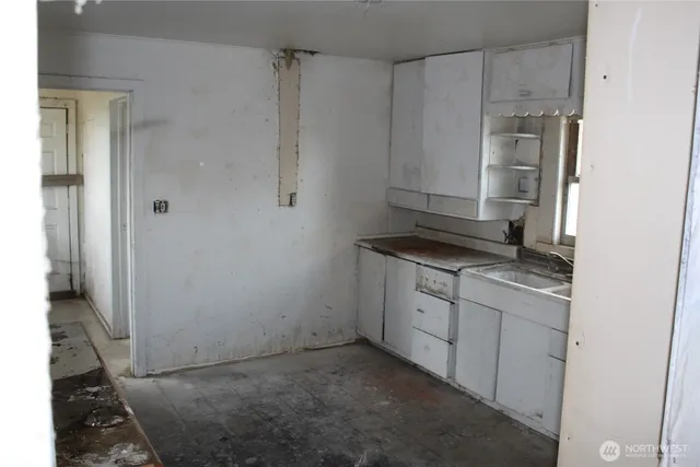 a kitchen with a sink stove and refrigerator