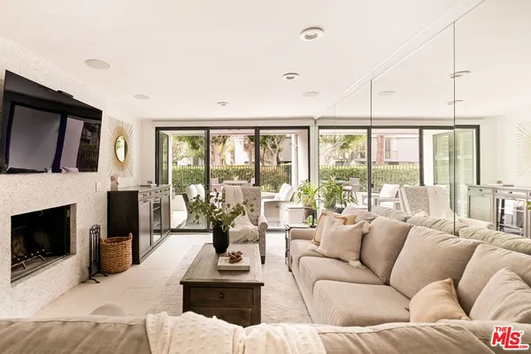 a living room with furniture fireplace and a flat screen tv