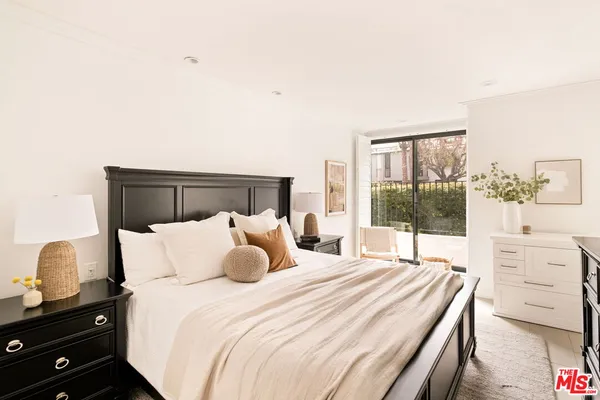 a bedroom with a bed and a night stand