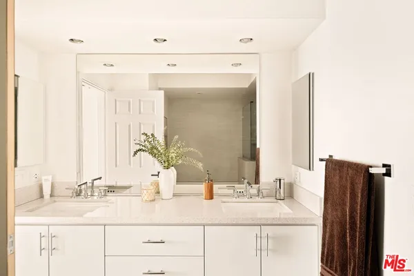 a bathroom with a double vanity sink and mirror