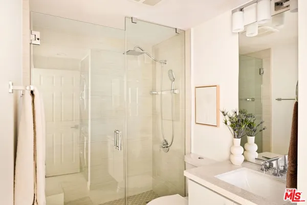 a bathroom with a shower curtain a mirror and a sink