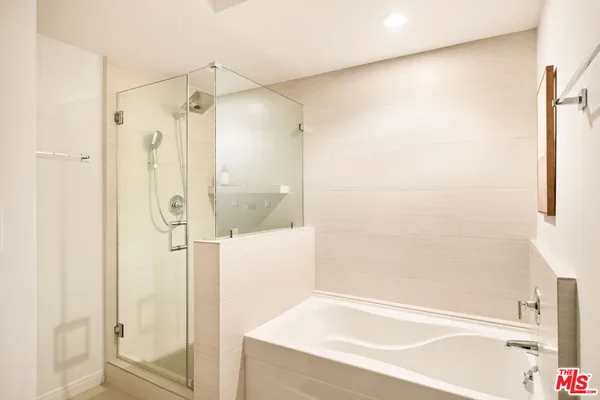 a bathroom with a bathtub and a shower