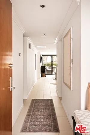 a view of hallway with wooden floor and a rug
