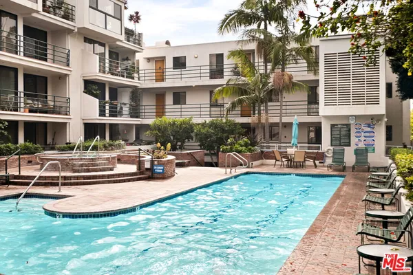 a view of a house with swimming pool and sitting area