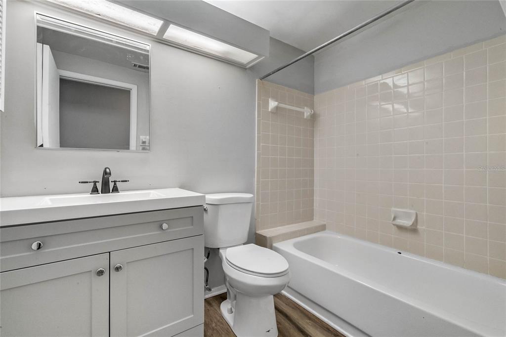 4907 Lake Ridge Road, Unit H Orlando, FL 32808 - Photo 13 of 14 a bathroom with a sink a toilet and shower