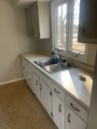 a kitchen with appliances cabinets and a sink