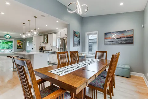 a view of a dining room with furniture and wooden floor