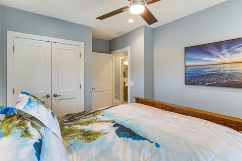 a bedroom with a bed and a painting on the wall