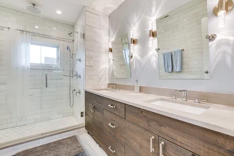 a bathroom with a granite countertop sink mirror and double