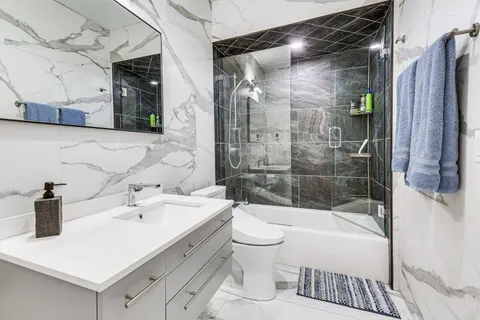 a bathroom with a sink toilet and shower