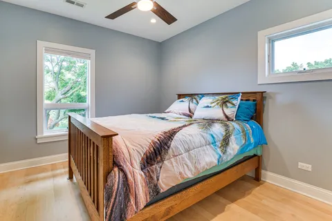 a bed sitting in a bedroom next to a window