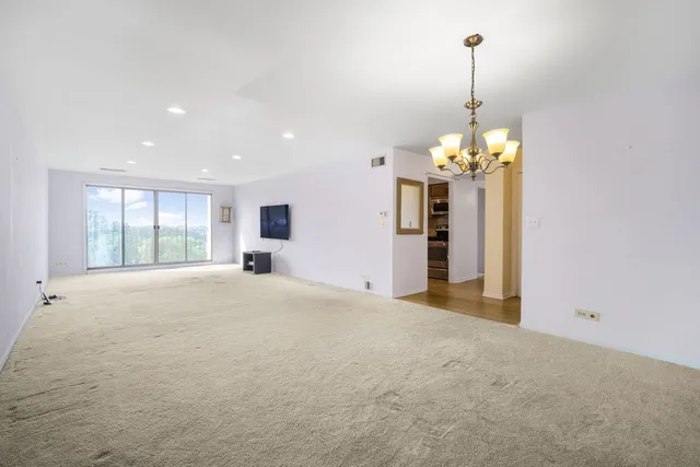 a view of a room with a windows and chandelier