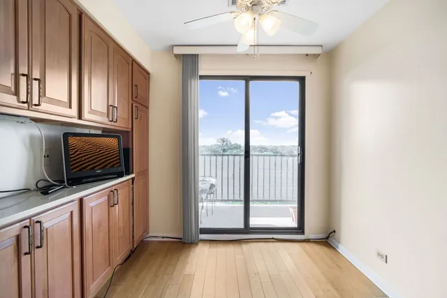 a view of a kitchen with an entryway and wooden floor