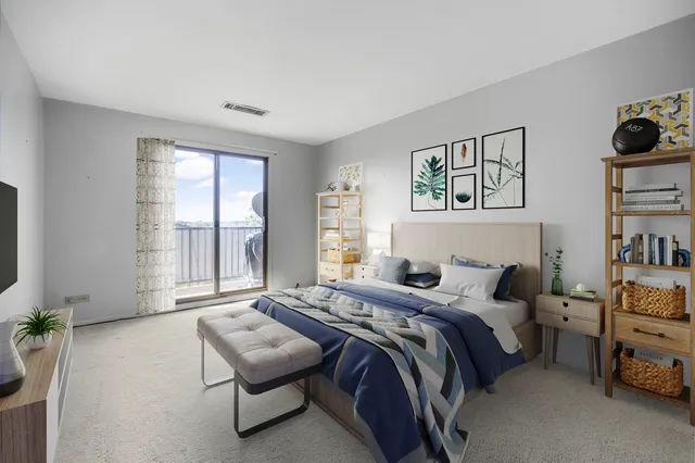 a bedroom with a bed and a large window