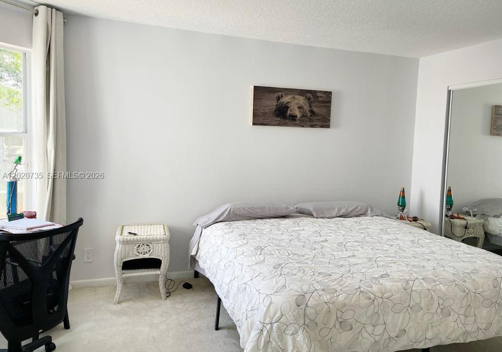 17244 Balboa Point Way Boca Raton, FL 33487 - Photo 34 of 66 a bedroom with a bed and a chair