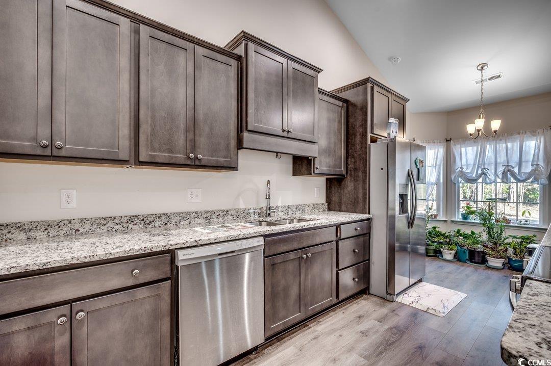 477 Cane Branch Road Loris, SC 29569 - Photo 12 of 27 Kitchen featuring sink, light stone counters, stai