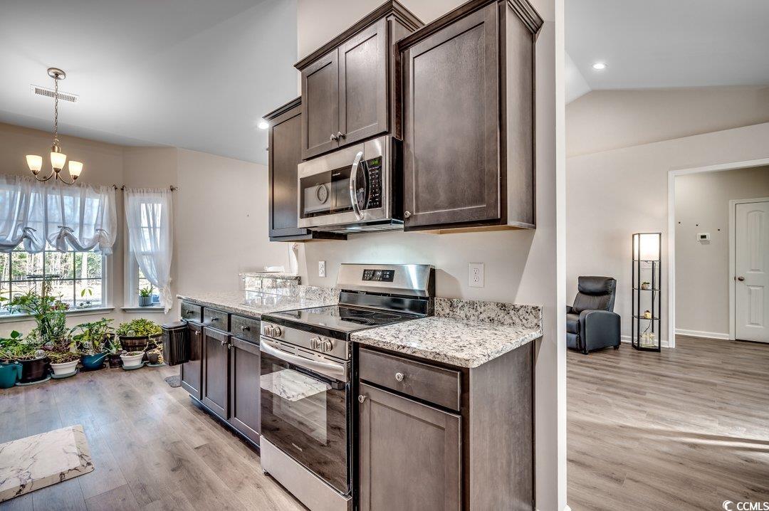 477 Cane Branch Road Loris, SC 29569 - Photo 13 of 27 Kitchen featuring light stone counters, appliances