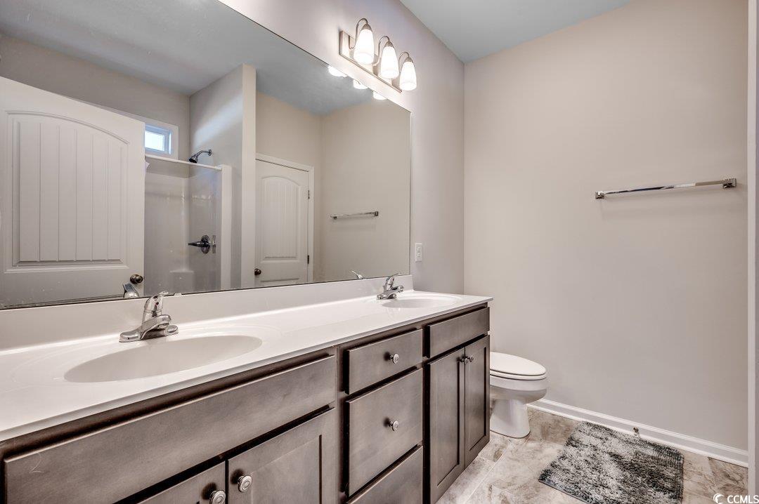477 Cane Branch Road Loris, SC 29569 - Photo 18 of 27 Bathroom with vanity, toilet, and a shower