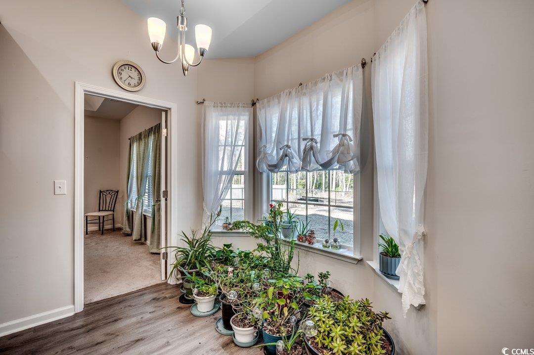 477 Cane Branch Road Loris, SC 29569 - Photo 9 of 27 Dining room with a notable chandelier and hardwood