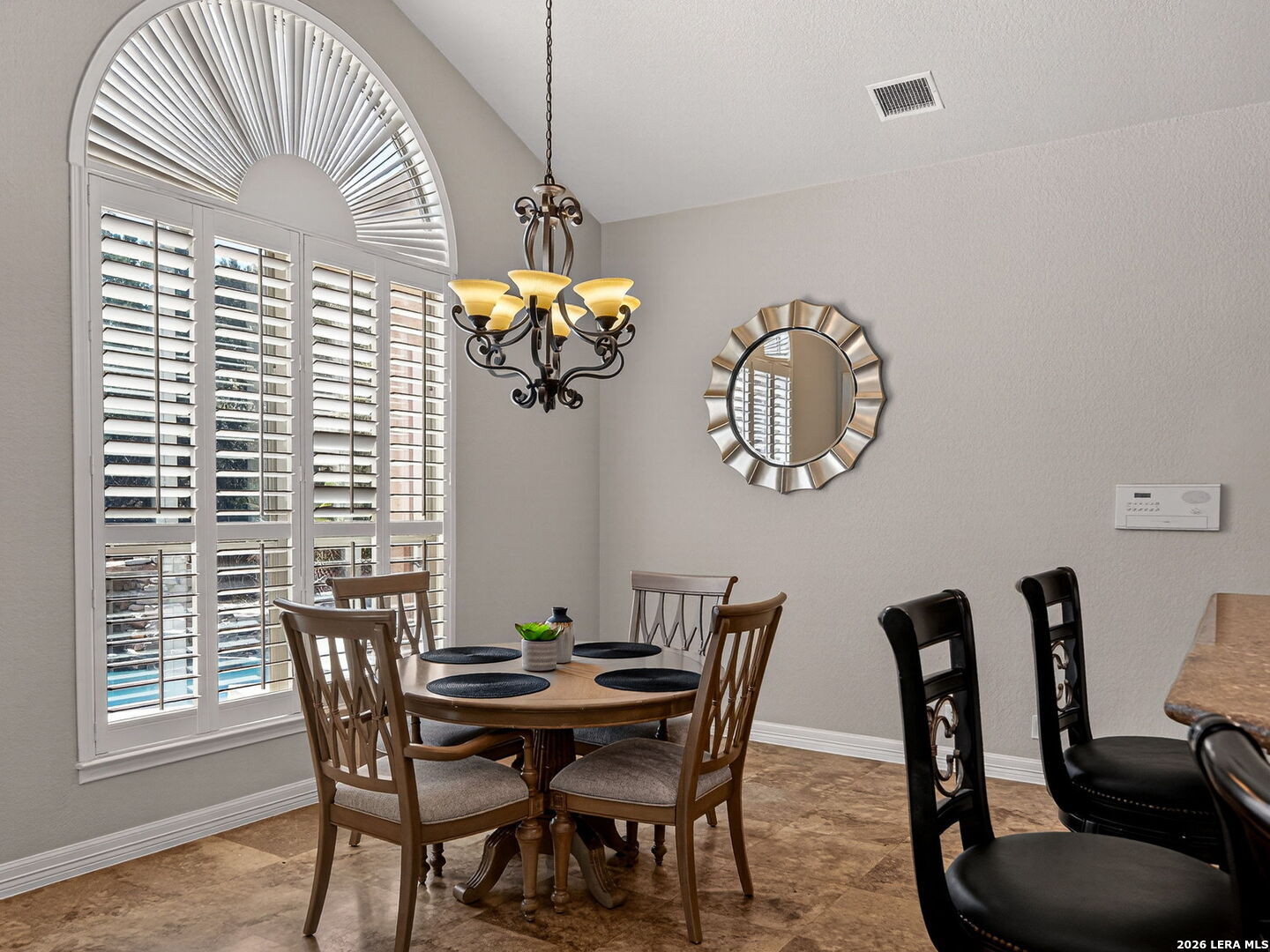 24511 Bogey Ridge San Antonio, TX 78258 - Photo 12 of 39 a view of a dining room with furniture a chandelier and wooden floor