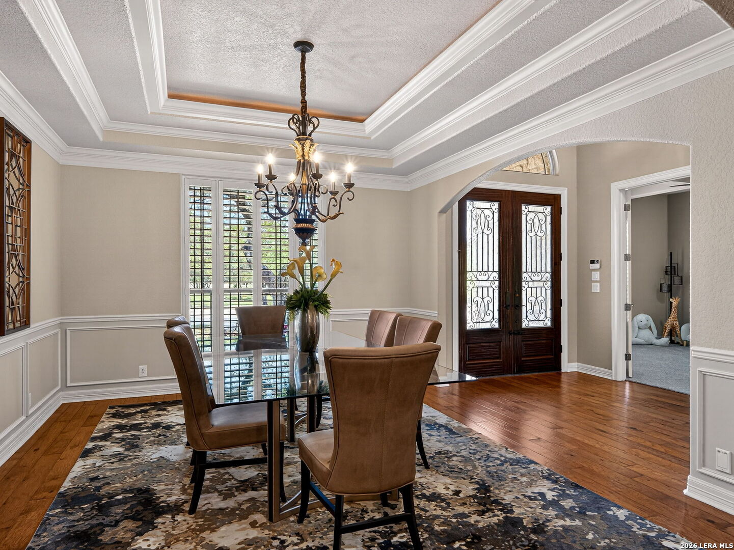 24511 Bogey Ridge San Antonio, TX 78258 - Photo 15 of 39 a dining room with furniture wooden floor a chandelier and a rug