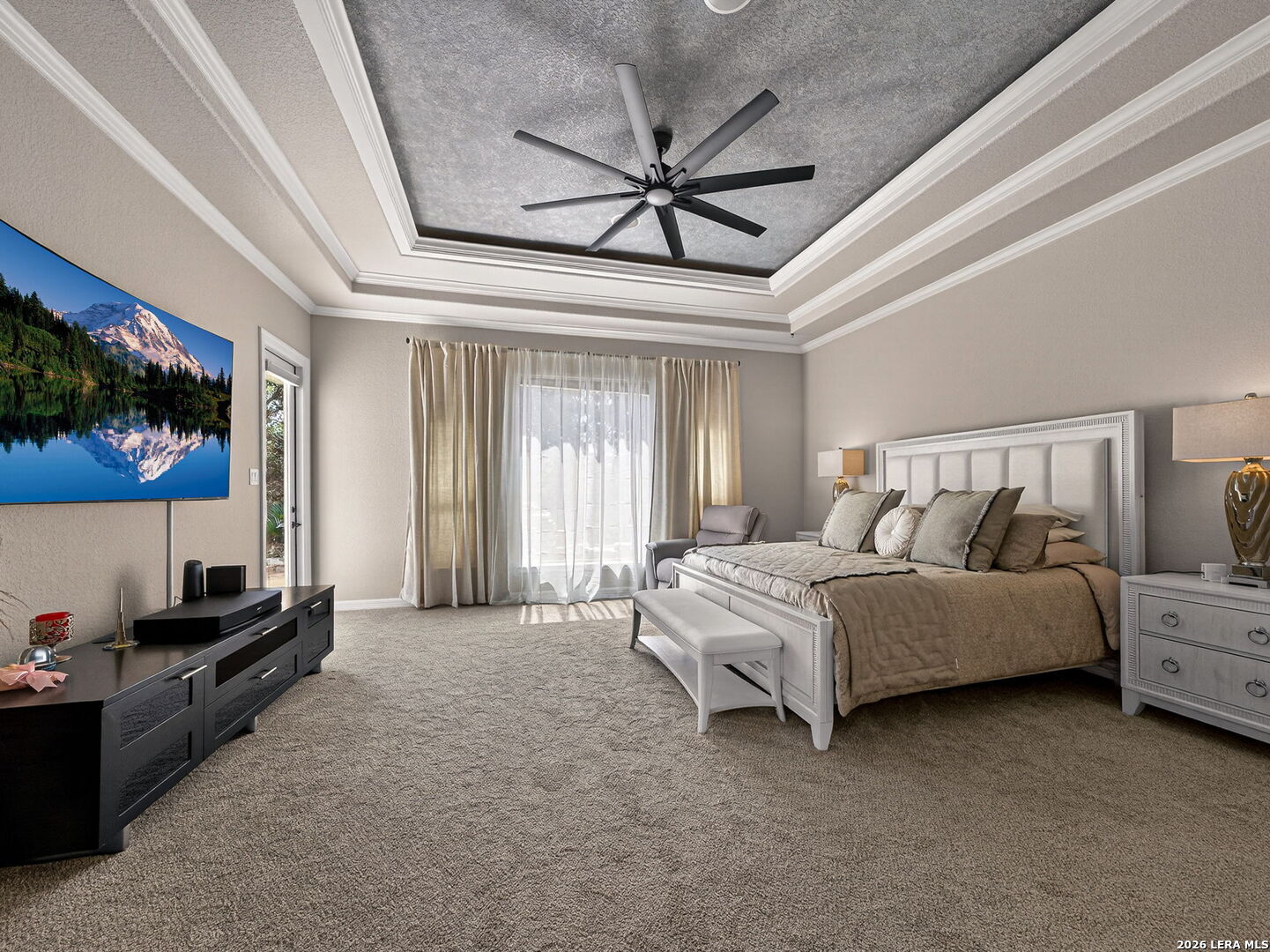 24511 Bogey Ridge San Antonio, TX 78258 - Photo 17 of 39 a spacious bedroom with a bed a couch and a flat screen tv